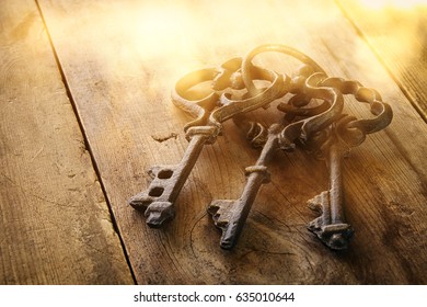 Image of antique keys on old wooden table. - Shutterstock ID 635010644