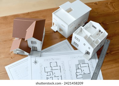 Image of architectural models and architectural drawings placed on a desk