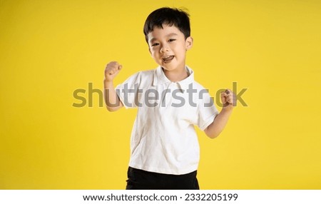 image of asian boy posing on a yellow background
