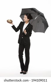 The Image Of Asian Business Woman With Umbrella And Nest