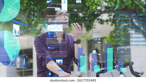 Image of asian businessman talking on smartphone over data processing. global business, finances, connections and digital interface concept digitally generated image.