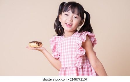 Image Of Asian Child Eating Cup Cake On Background