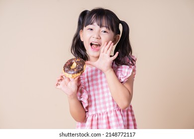 Image Of Asian Child Eating Cup Cake On Background