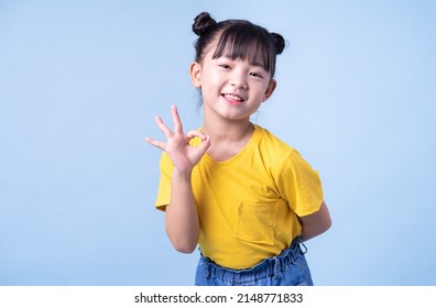 Image Of Asian Child Posing On Blue Background