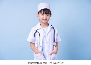 Image Of Asian Child Wearing Doctor Uniform On Blue Background