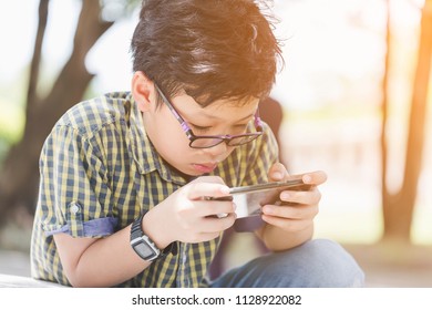 Image Of Asian Children Realized He Was Hooked On Video Games Or Smartphone When He Stayed Up All Day Playing Them, And Then Failed An Important Exam. Childhood, Technology And People Concept 