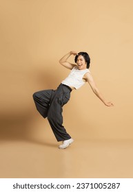 Image of Asian dancer dancing on beige background