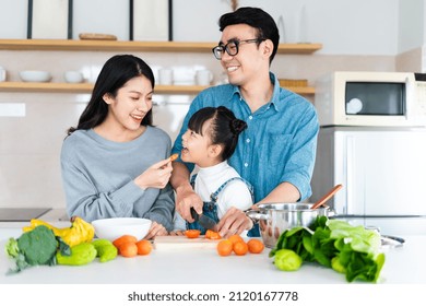 Image Of An Asian Family Cooking At Home