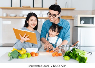 Image Of An Asian Family Cooking At Home