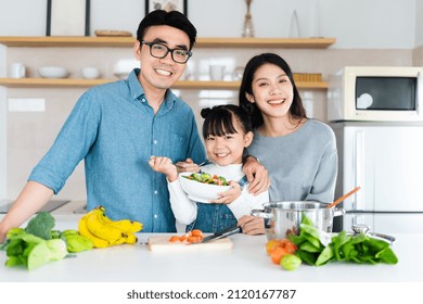 Image Of An Asian Family Cooking At Home