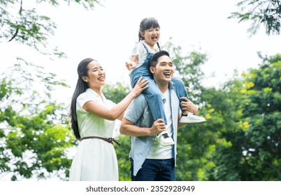 image of asian family walking in the park - Powered by Shutterstock