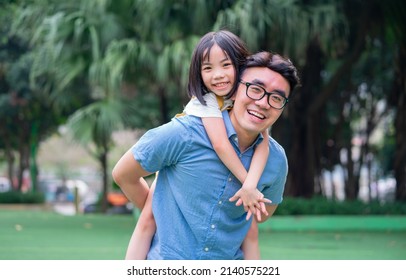 Image Of Asian Father And Daughter Playing Together At Park