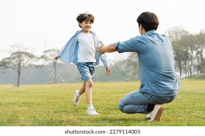 image of an asian father and son having fun in the park - Powered by Shutterstock