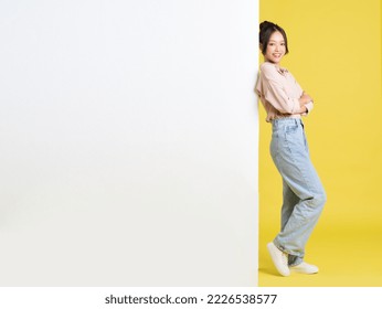 image of Asian girl standing and posing with billboard - Shutterstock ID 2226538577
