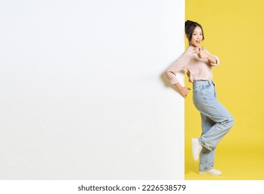 image of Asian girl standing and posing with billboard - Shutterstock ID 2226538579