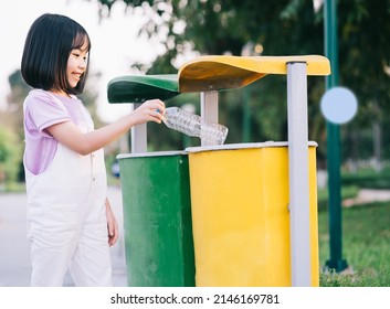 Image Of Asian Little Girl Puts Used Plastic Bottles In The Trash