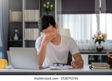 Image Asian Man Are Stressed, Pain In Their Eyes, Work With Their Laptop, Taking Notes At Home.