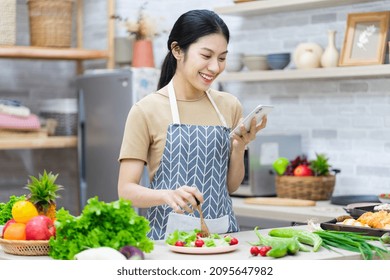 Image Of Asian Woman Preparing Salad In The Kitchen