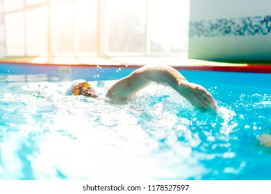 Image Of Athlete Man From Side Swimming In Pool At Workout.