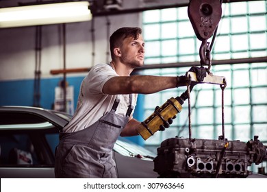 Image Of Auto Workshop Worker Using Engine Hoist