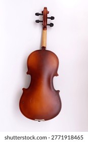 Image of back side of a violin, a string instrument typically used in classical and folk music on black background. 