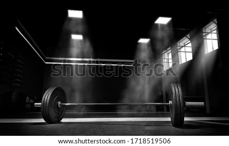 Image of barbell in the gym. The concept of sport and healthy lifestyle. Mixed media