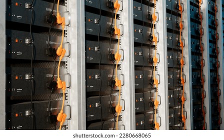 Image of a battery energy storage system consisting of several lithium battery modules placed side by side. This system is used to store renewable energy and then use it when needed. - Shutterstock ID 2280668065