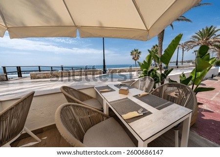 an image of a beachfront restaurant table along the boulevard on Marbella
