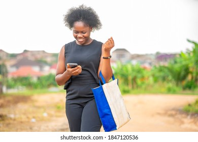 Image Of Beautiful African Lady, With Phone- Out Door Shopping Concept