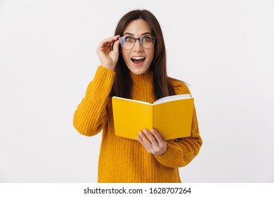 Image of beautiful brunette adult woman wearing eyeglasses making notes in diary book isolated over white background - Shutterstock ID 1628707264