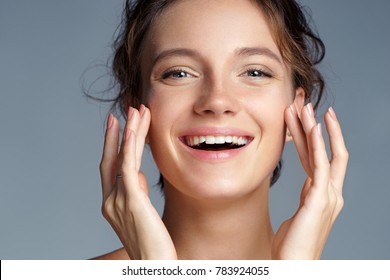 Image With Beautiful Brunette Girl Touching Her Face On Grey Background. Close Up. Beauty & Skin Care Concept