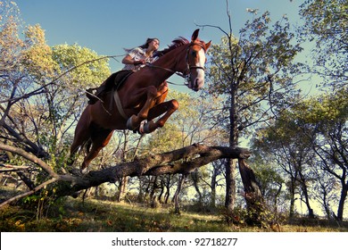 Image of Beautiful girl with purebred horse, jumping a hurdle in forest - Powered by Shutterstock