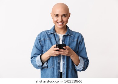 Image Of A Beautiful Happy Bald Woman Posing Isolated Over White Wall Background Using Mobile Phone.