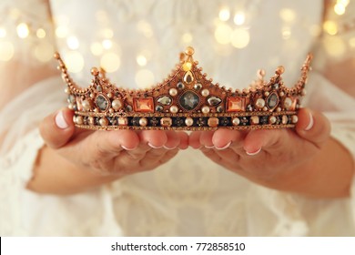 image of beautiful lady with white lace dress holding diamond crown. fantasy medieval period