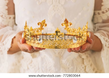 image of beautiful lady with white lace dress holding diamond crown. fantasy medieval period