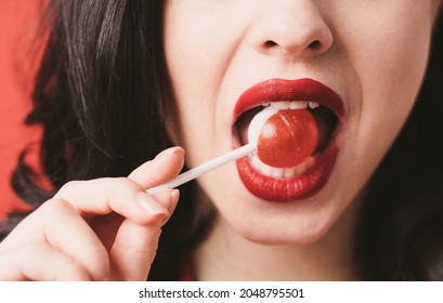 Image Of A Beautiful Woman Eating A Fruity Lollypop