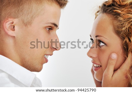 Image of a beautiful young couple looking at each other and smiling