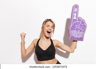 Image of a beautiful young fitness woman isolated over white wall background holding number one glove fan.