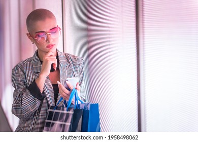 Image Of A Beautiful Young Woman Posing Against A Led Panel. Shaved Head Teenager With Alternative Look Making Urban Portraits