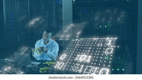 Image of binary codes, african american man feeding cable details in laptop at server room. Digital composite, multiple exposure, coding, data center, networking and technology concept.