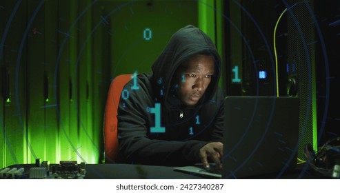 Image of binary coding over african american male hacker with computer and computer servers. Global online virus, computing and data processing concept digitally generated image.