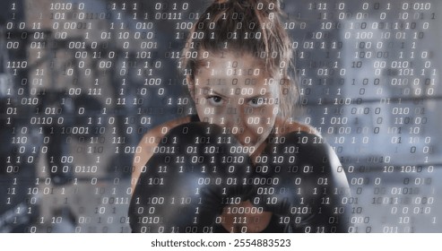 Image of binary coding over caucasian woman wearing boxing gloves at gym. Sport and digital interface concept digitally generated image. - Powered by Shutterstock