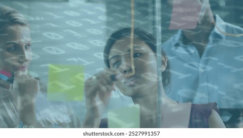 Image of binary coding over diverse business people taking notes. global business, finances and digital interface concept digitally generated image.