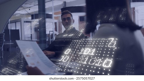 Image of binary coding over diverse business people working together in office. Global finance, business, connections, computing and data processing concept digitally generated image.