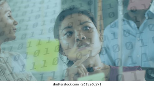 Image of binary coding over diverse business people taking notes. global business, finances and digital interface concept digitally generated image.