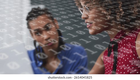 Image of binary coding over diverse business people using laptop. social media and communication interface concept digitally generated image.