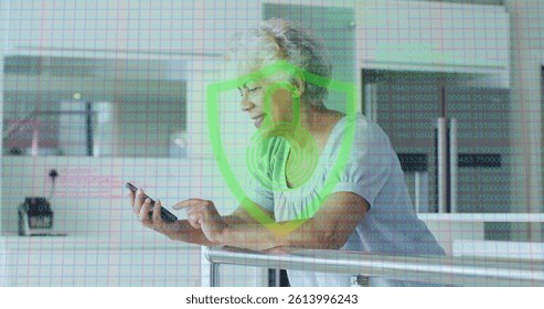 Image of biometric fingerprint padlock over senior woman using smartphone. global connections, online identity and data processing concept digitally generated image.