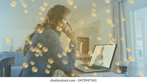 Image of bitcoin symbols over businesswoman using phone headset and laptop. global cryptocurrency, data processing, digital interface and technology concept digitally generated image.