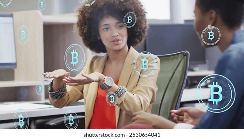 Image of bitcoin symbols over diverse colleagues discussing work in office. Business, communication, technology, computing and digital interface concept digitally generated image. - Powered by Shutterstock