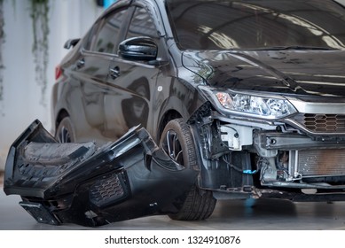 The image of a black car caused an accident until the air conditioner panel and the radiator panel damaged. The front bumper dropped out of the car. Waiting for insurance to claim - Shutterstock ID 1324910876
